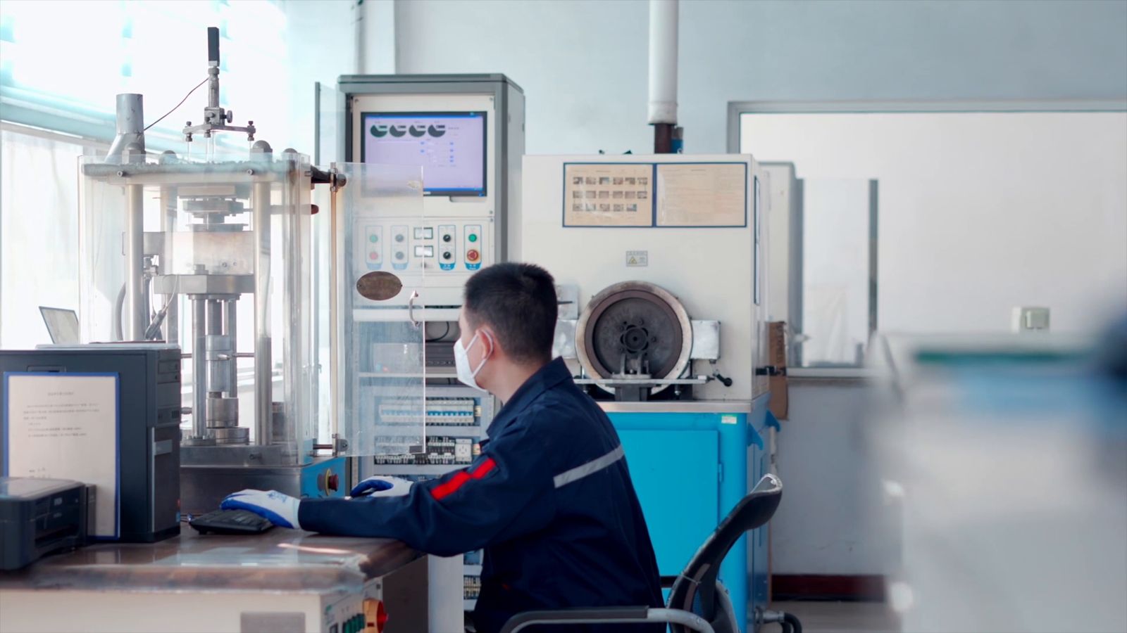 Technician operating a brake pad test bench